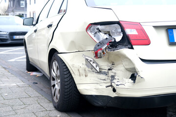 wrecked car close-up, severely damaged fenders car after car accident, Huge dent in car body,...