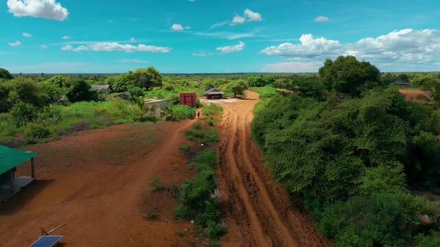 Aerial footage of Androhibe Village, Madagascar, showcasing houses, dirt roads, and the vibrant layout of this tropical rural community.