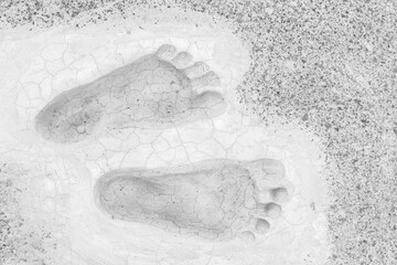 Grey footprints on floor top view background
