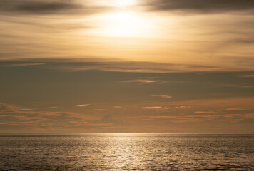 Obraz premium Landscape of colorful clouds in sunset or sunrise sky over sea with reflection in the tropical sea,Beautiful seascape scenery,Amazing light of nature Landscape nature background