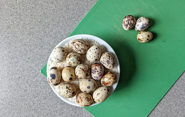 Quail eggs on wooden plate. Quail eggs can be consumed by frying or boiling. In Indonesia quail eggs are called quail. Selective focus