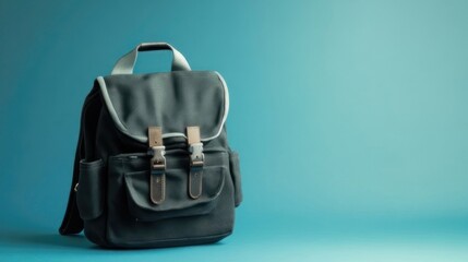 Naklejka premium Dark Backpack on Teal Background