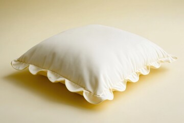 A creamy white square pillow with ruffled edges on display