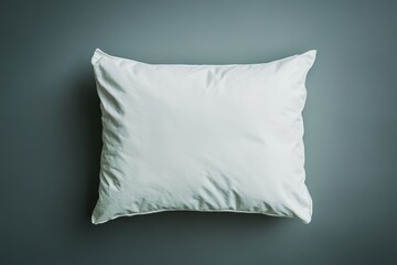 Obraz premium A single white pillow resting upon a neutral colored background