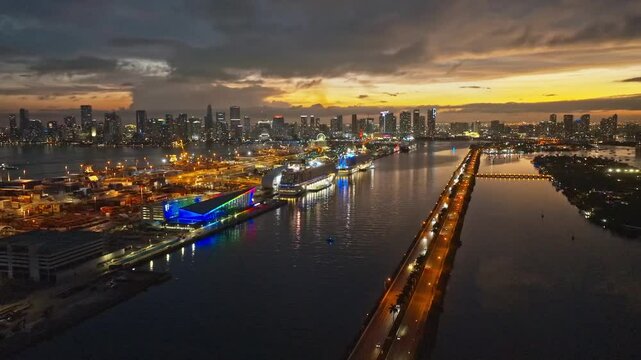 Miami Beach city at night with dramatic sky. Miami Beach seaside at dusk. Aerial view of evening Miami Beach and cityscape. Coastline of Miami Beach city, night shot. American city.