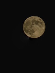 Winter Full Moon in the black night sky
