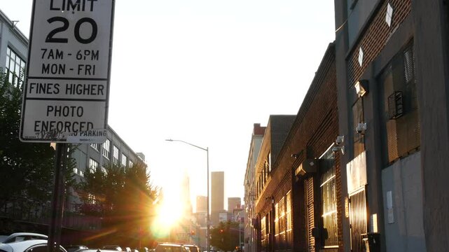 New York City street crossroad, speed limit traffic sign, transport road signage, United States. Queens, Long Island. Manhattan cityscape. Sunset, golden hour sunshine rays.
