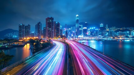Fototapeta premium Hong Kong'S Vibrant Night With Car Light Trails And Cityscape Reflecting In The Water.