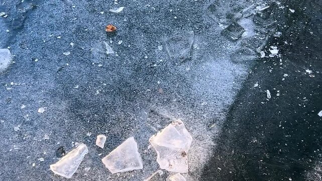 The ice surface of a frozen pond in winter.