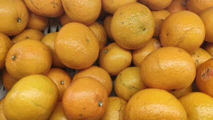 the background of a collection of orange sunkist. fresh orange sunkist that is ready to sell in the market.