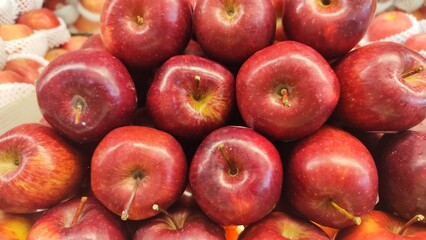 Red ripe apples on display in fruit shops are sold for juice or eaten directly