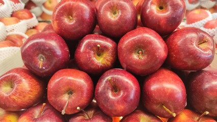 Red ripe apples on display in fruit shops are sold for juice or eaten directly
