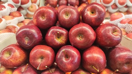 Red ripe apples on display in fruit shops are sold for juice or eaten directly