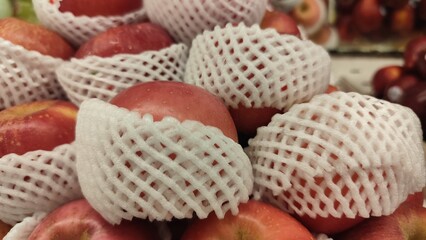 Red ripe apples on display in fruit shops are sold for juice or eaten directly