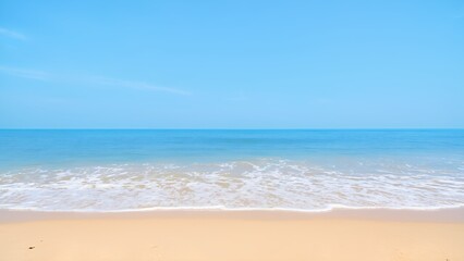 Fototapeta premium Serene sandy beach with crystal clear turquoise waters, calm waves, and a peaceful sky