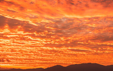 Dramatic sunset clouds over mountain hill 