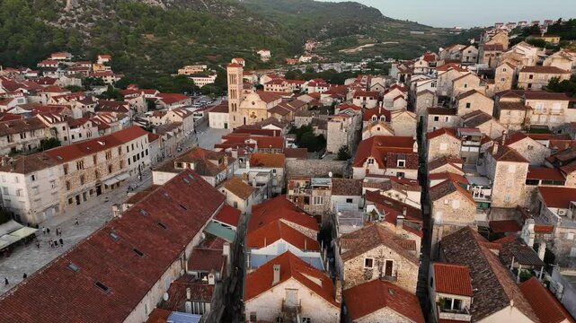 Aerial view of the historic city center of Hvar with its cathedral and red roofs.