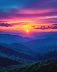 Fototapeta premium Colorful Mountainous Horizon with Radiant Sunrise and Layered Ridges in Atmospheric Perspective