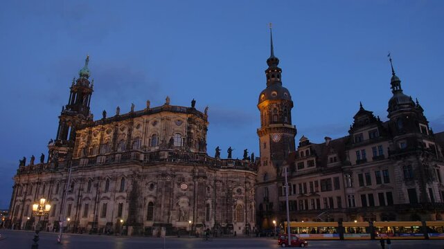 Hausmannsturm Dresden Hofkirche Sanctissimae Trinitatis saxony Sachsen Germany cathedral at dusk with train illuminated against the deep blue evening sky medium shot