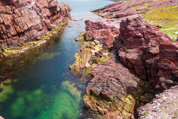 Tickle Cove Sea Arch on Bonavista Peninsula in Eastern Newfoundland is one of the main attractions on the Discovery Trail. The arch is a result of the erosion of red sandstone by the Atlantic Ocean.