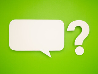 White speech bubble and question mark cutout on a vibrant green background.