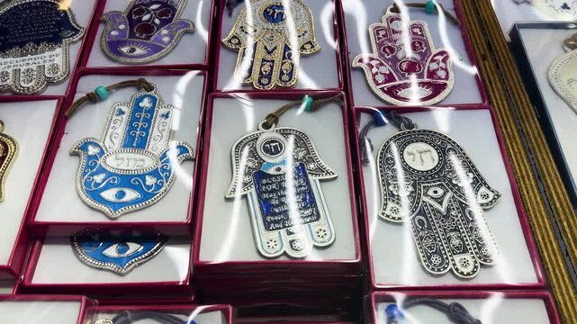 Nazar in market. Blue and red Fatima eye close-up protective amulet against evil eye. Israeli Hamsa David