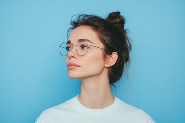 Fototapeta premium Beautiful Young Woman Wearing Glasses Looks Towards The Right