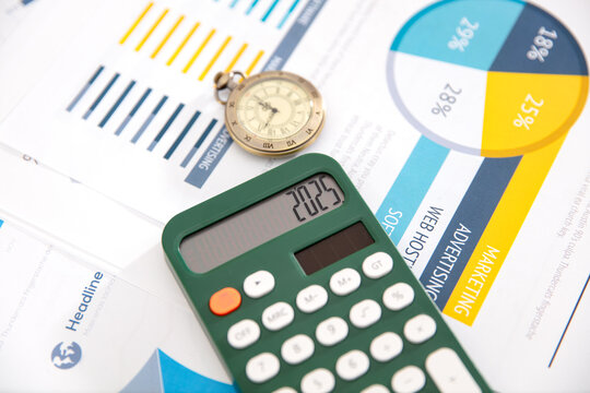 Calculator and pocket watch and document background