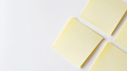 Blank yellow sticky note with a subtle shadow positioned diagonally on a crisp white background for a clean modern look