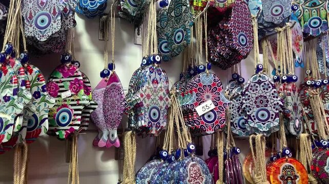 Nazar in market. Blue and red Fatima eye close-up protective amulet against evil eye. Israeli Hamsa David