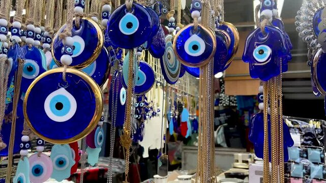 Nazar in market. Blue and red Fatima eye close-up protective amulet against evil eye. Israeli Hamsa David