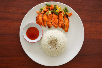 Crispy and golden brown Chicken Katsu with vegetables, white rice and sauce, Japanese food, Asian food