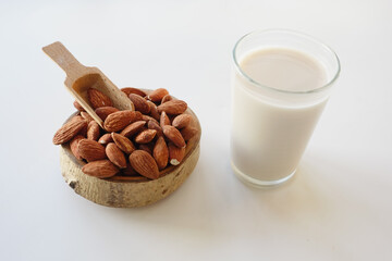 Almonds and almond milk displayed in a rustic setting
