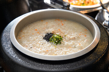 Warm vegetable white rice porridge in a stainless steel plate
