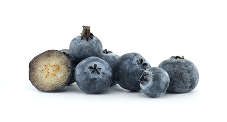 A cluster of plump blueberries, including a cross-section, are displayed on a white surface.