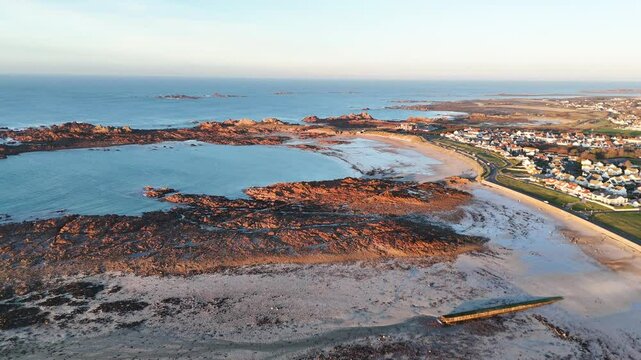 Drone reveal shot of cobo beach Guernsey at low tide 20