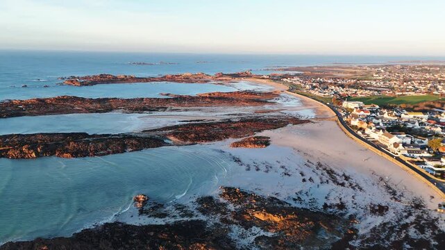 Drone reveal shot of cobo beach Guernsey at low tide 22