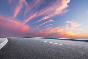 Asphalt road with beautiful sky clouds at sunset