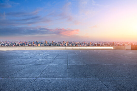 Shanghai cityscape view from empty rooftop platform at sunrise