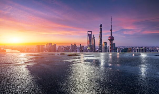 Shanghai skyline at sunrise with reflection on wet ground