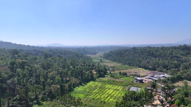 A landscape drone video panorama of green hills with  sky on the background in Coorg, faddy field and Indian road India. shot in 21\02\2025