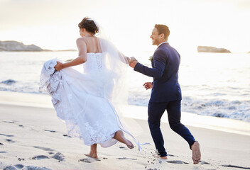 Wedding, running and couple on beach holding hands and happy for celebration, ceremony and marriage. Love, nature and man and woman by ocean together for romance, commitment and promise on island