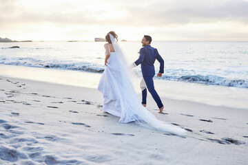Wedding, running and back of couple on beach for celebration, ceremony and marriage in nature. Honeymoon, holding hands and man and woman by ocean for romance, commitment and relationship for love