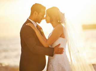 Wedding, love and couple on beach at sunset for celebration, ceremony and marriage in nature....