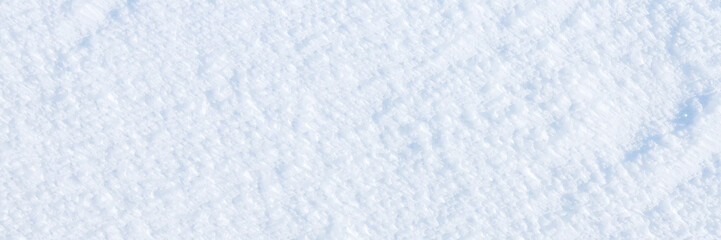 Obraz premium Natural snow texture. The surface of an icy snow crust. Snowy ground. Winter background with snow patterns. Perfect for Christmas and New Year design. Closeup top view.