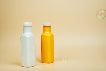 Shampoo and hair conditioner on a beige background. Foam and soap bubbles. Space for text. Advertising banner, mockup