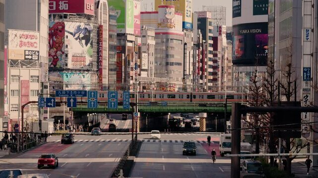 SHINJUKU,TOKYO,JAPAN : 17 Feb 2025 :crowd of people at zebra and train at near Kabukicho downtown area. Buildings, train and street traffic. Japanese urban city