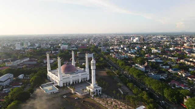 The beauty of the Great Mosque of Mujahidin at dusk seen from a height with a view of the surrounding Pontianak city. This mosque is the largest mosque in Pontianak City, West Kalimantan, Indonesia.