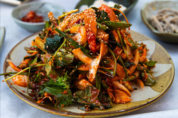 raw gizzard shad salad seasoned with spicy sauce and vegetables
