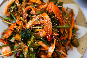 raw gizzard shad salad seasoned with spicy sauce and vegetables
